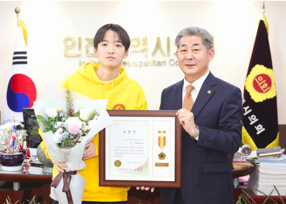 Award presentation with a gold medal at a ceremony